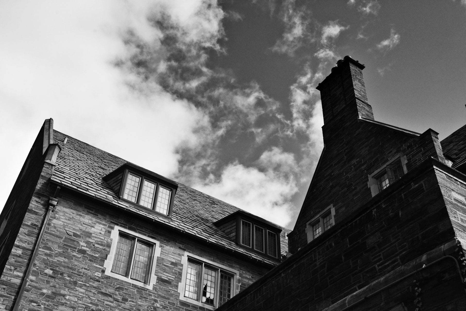 A large brick house with a visible chimney on top of the building