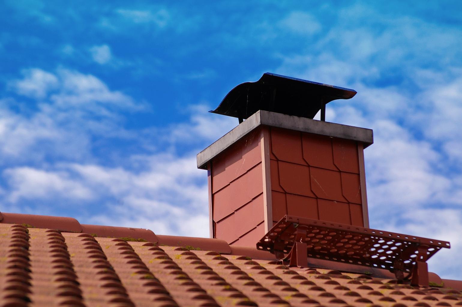 A chimney on a red brick house